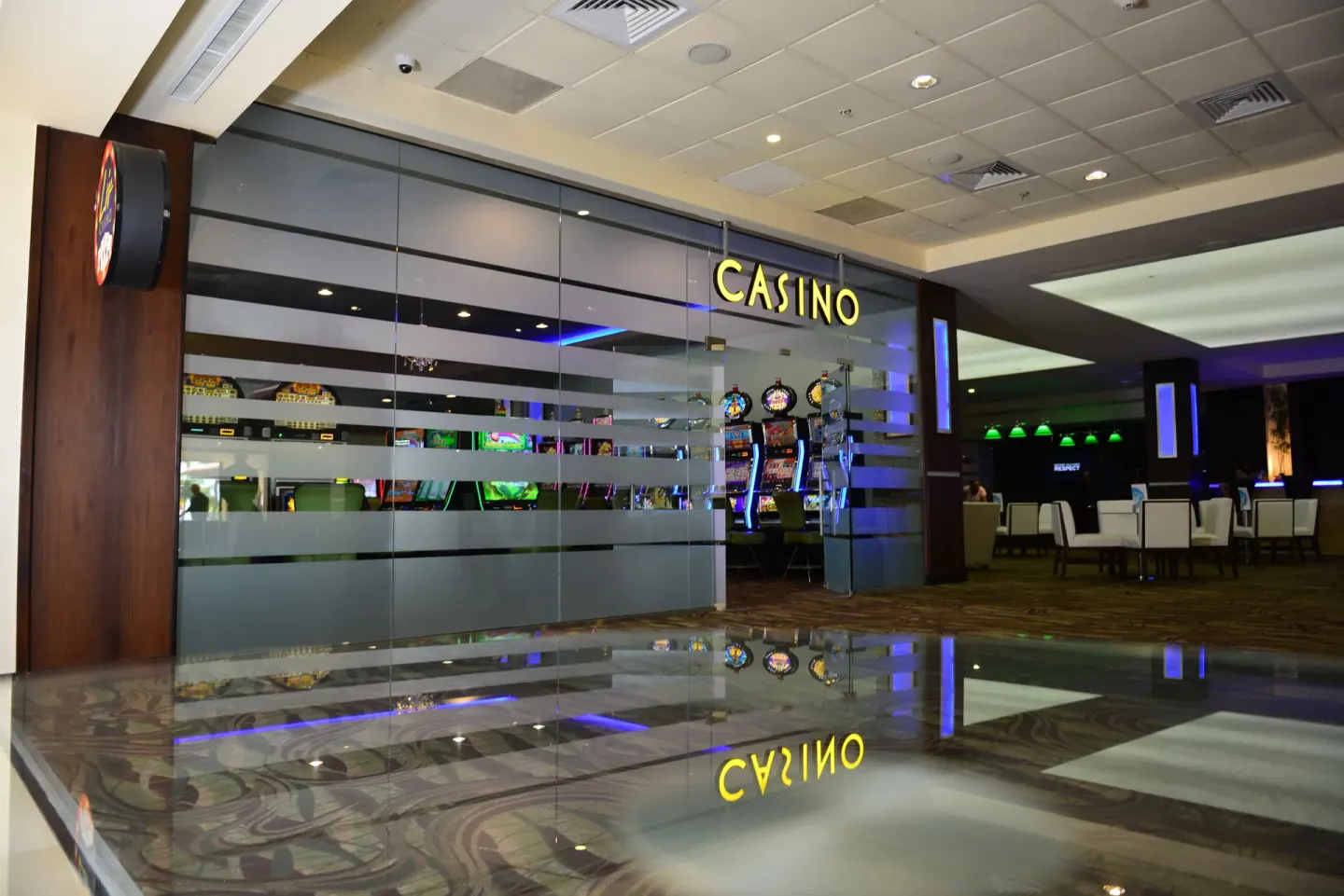 Casino entrance with glass walls and illuminated signage at Barceló Aruba.