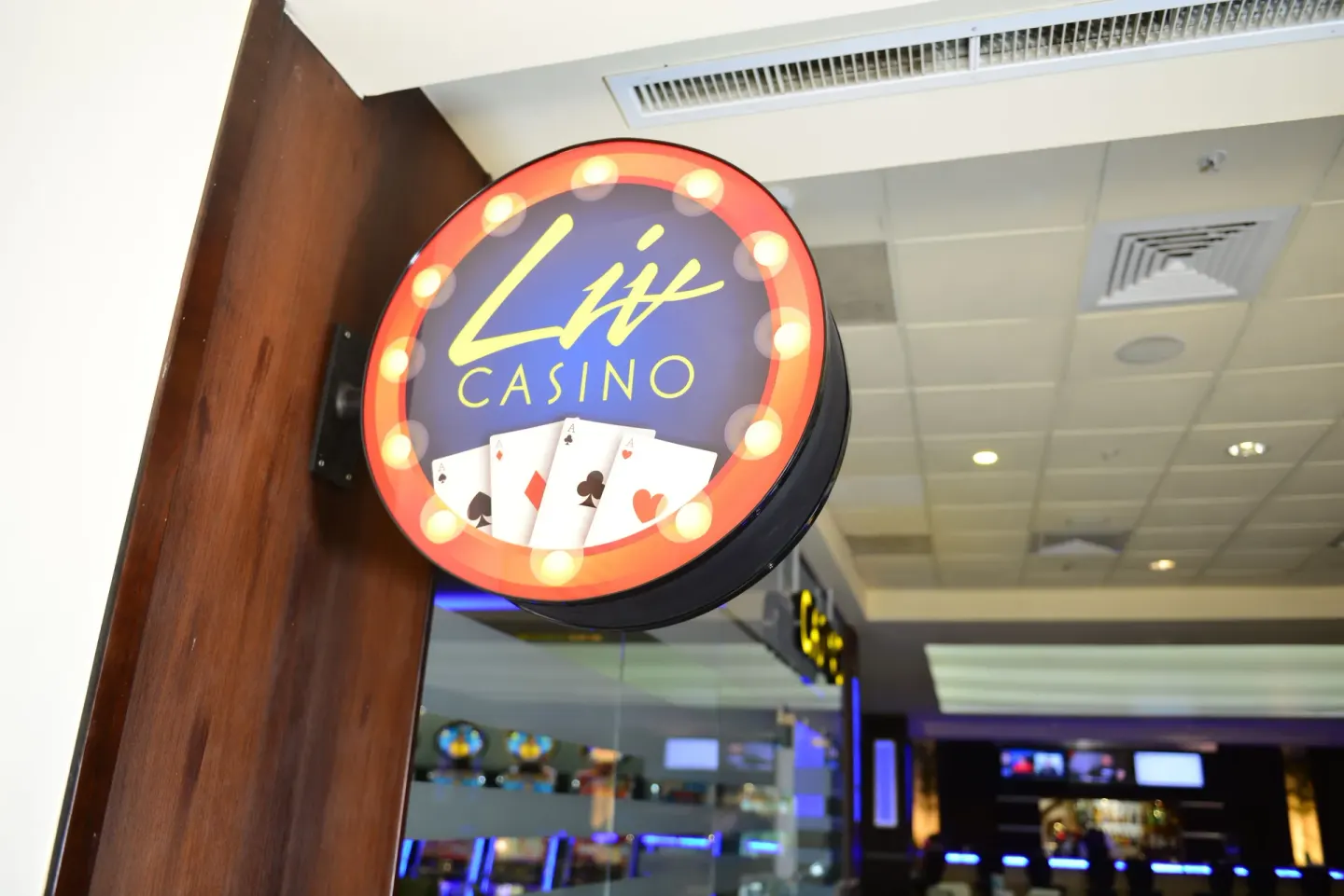 Lit casino sign with playing cards at Barceló Aruba.