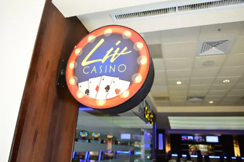Lit casino sign with playing cards at Barceló Aruba.