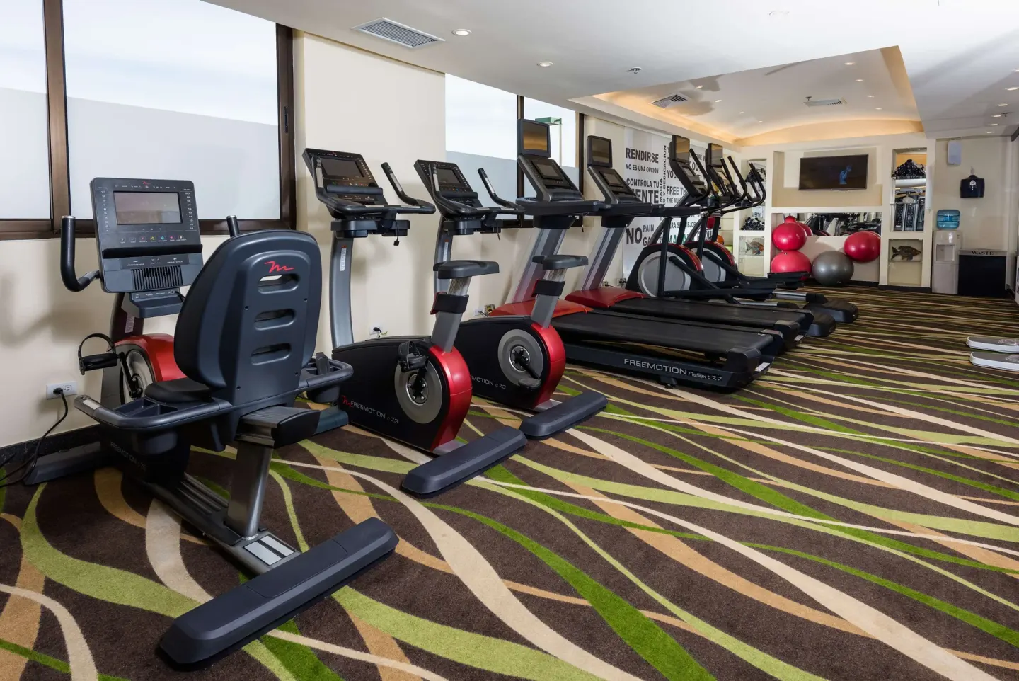 Fitness room with treadmills, exercise bikes, and stability balls at Barceló Aruba.