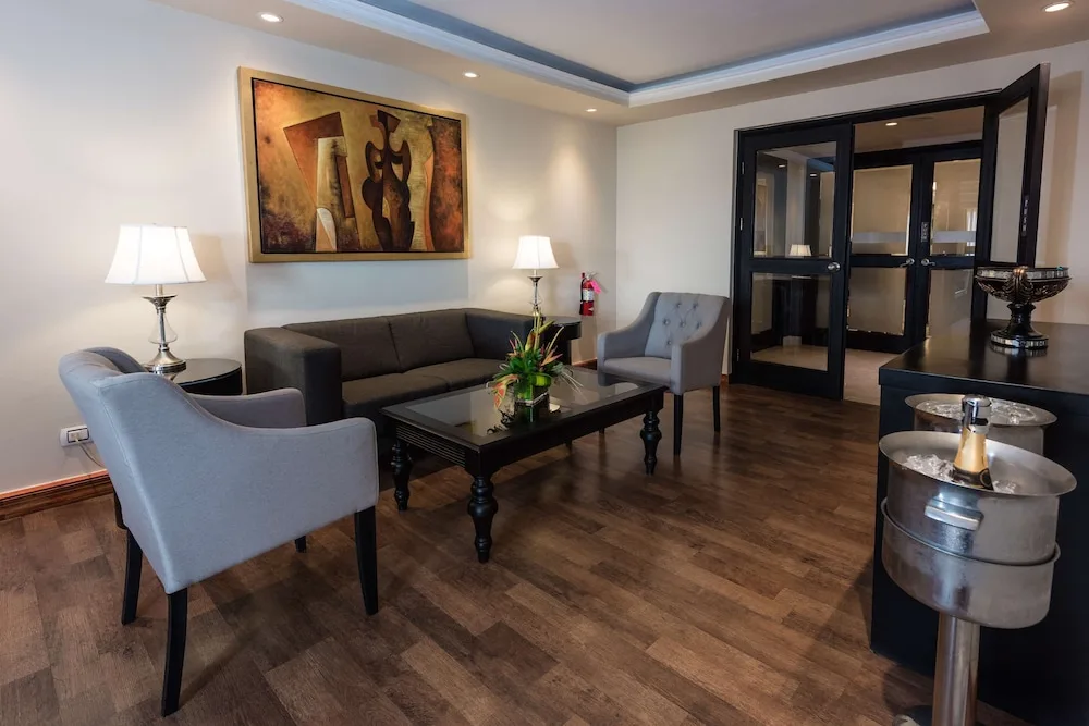 Private lounge seating with sofa, armchairs, and beverage cooler at Barceló Aruba.