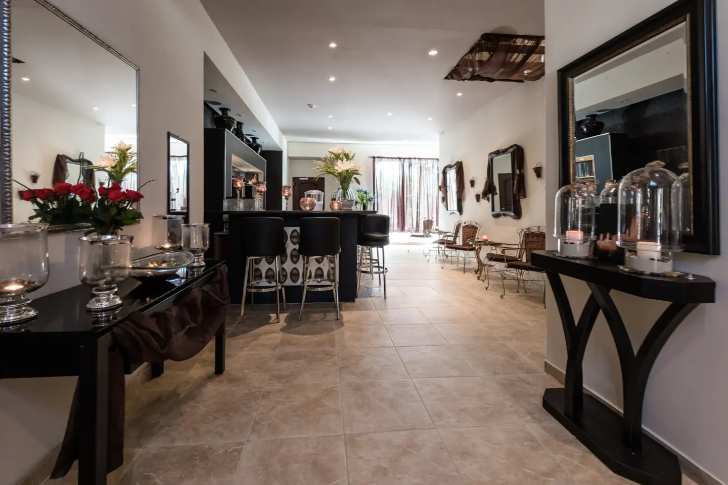 Spa lounge with bar counter, mirrors, candles, and seating at Barceló Aruba.