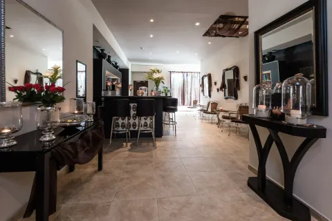 Spa lounge with bar counter, mirrors, candles, and seating at Barceló Aruba.
