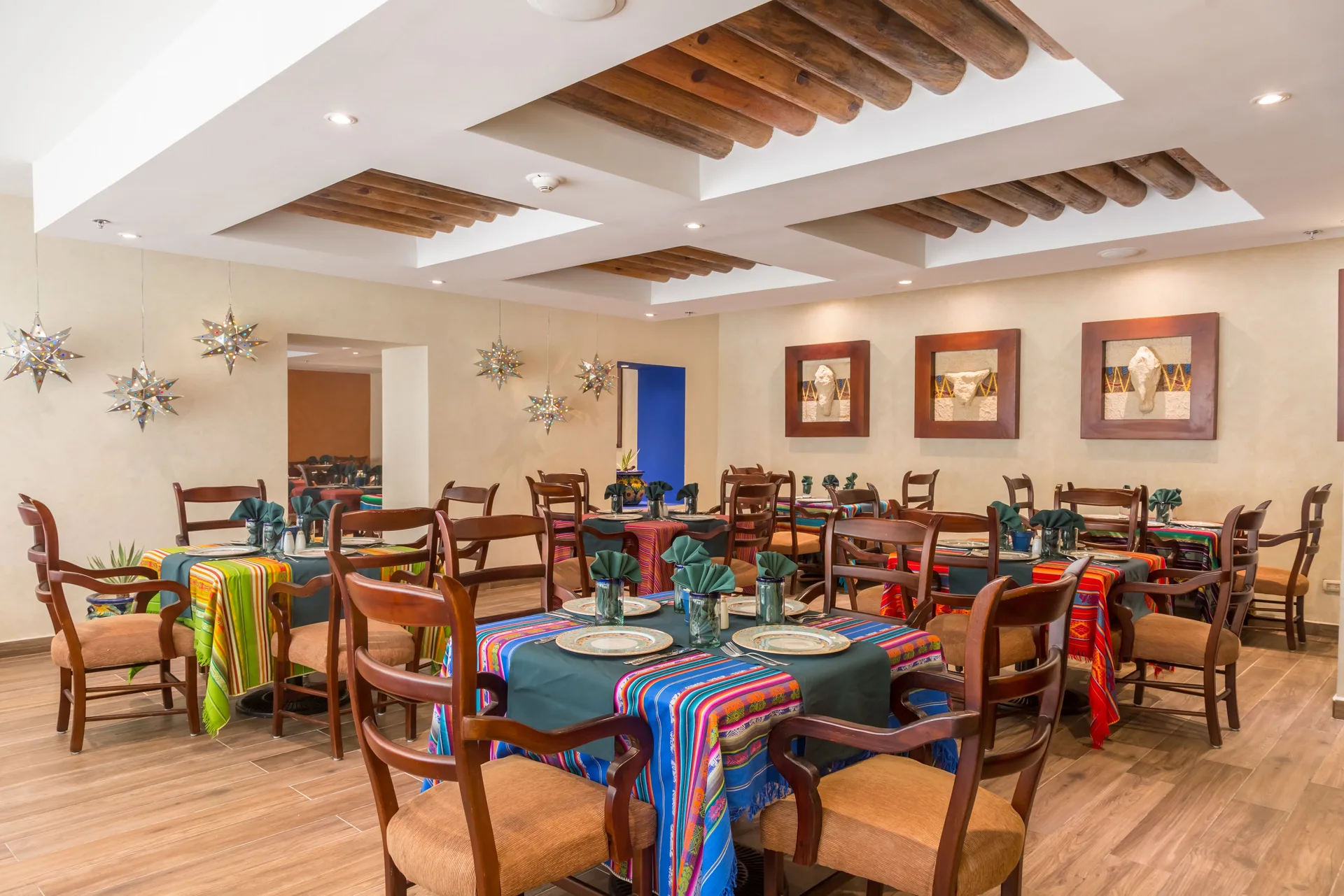 Mexican-style dining room with colorful table runners at Barceló Aruba.
