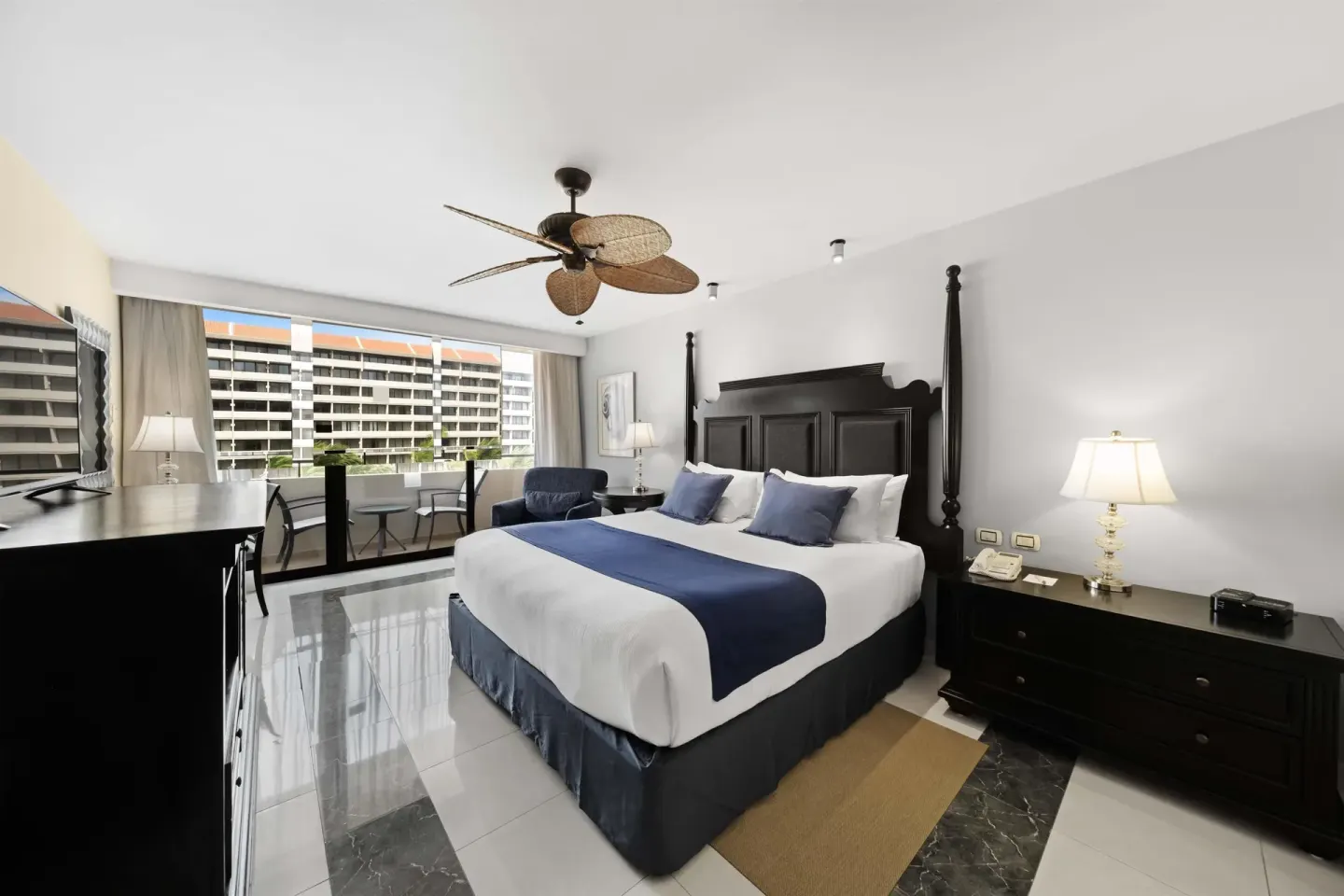 Deluxe Pool Ocean View king room with balcony seating at Barceló Aruba.