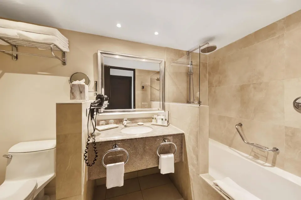 Luxury Ocean View Royal Level bathroom with tub shower and vanity at Barceló Aruba.