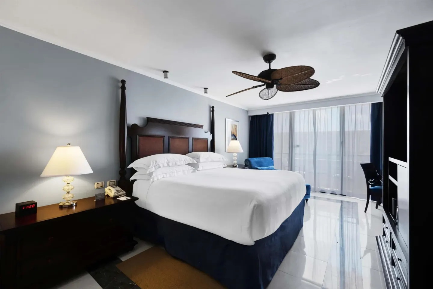 Luxury Ocean View Royal Level room with king bed and sheer balcony curtains at Barceló Aruba.