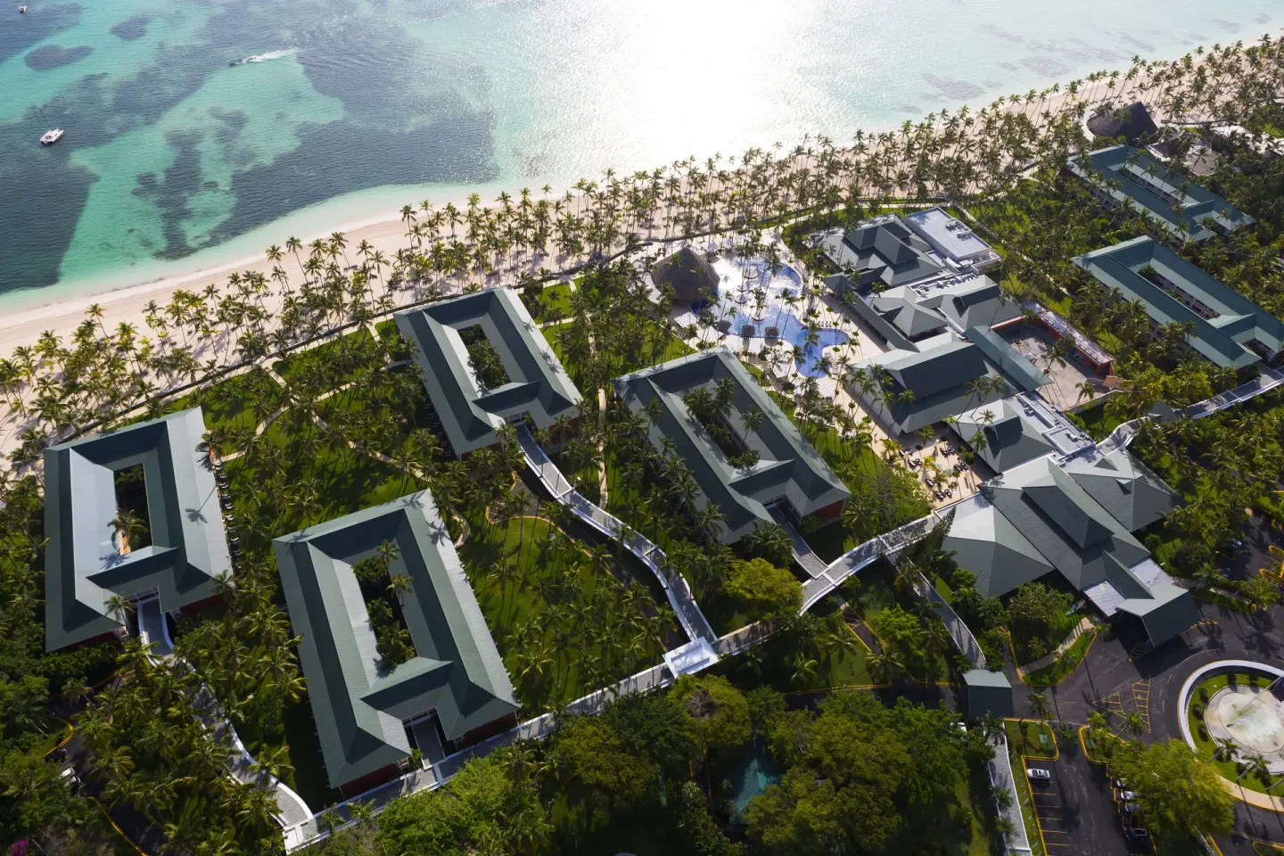 Aerial view of beachfront buildings and palms at Barceló Bávaro Beach.