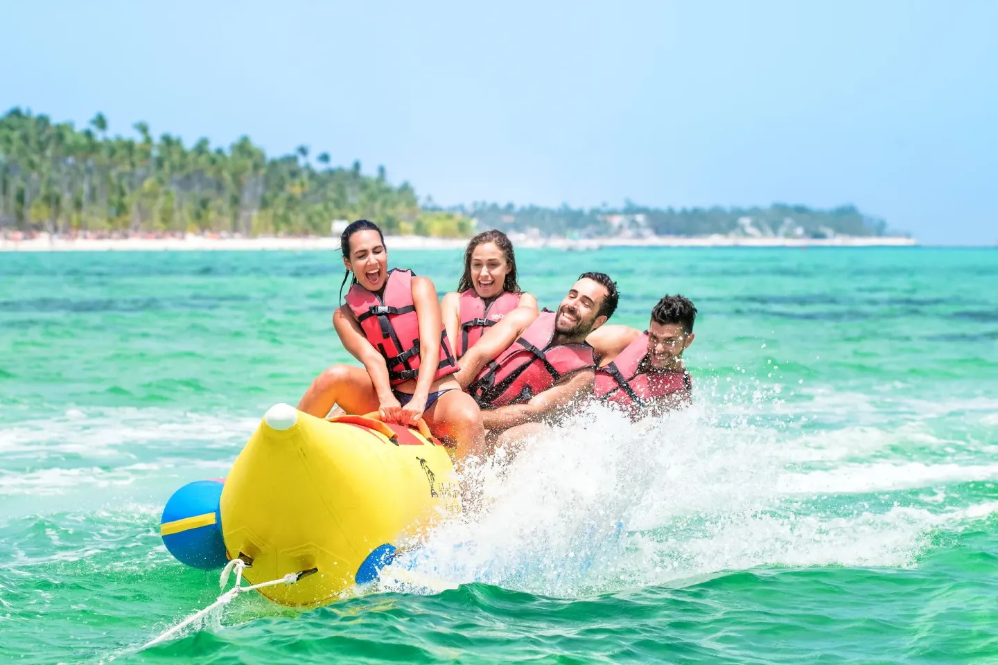 Guests ride a yellow banana boat through the surf at Barceló Bávaro Beach.