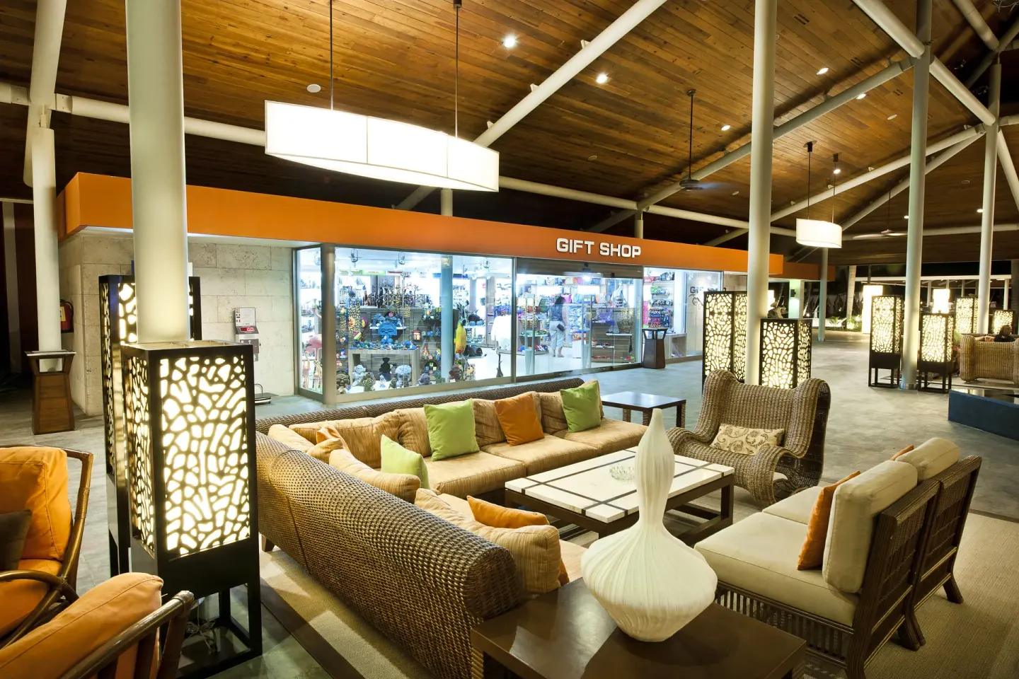 Lobby seating faces a gift shop storefront at Barceló Bávaro Beach.
