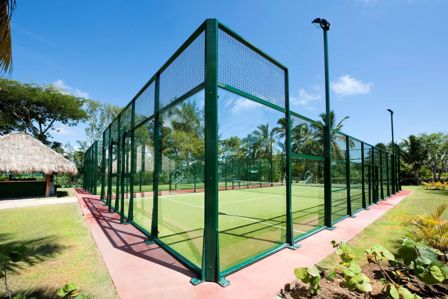 Outdoor padel-style court enclosed in green glass fencing at Barceló Bávaro Beach.