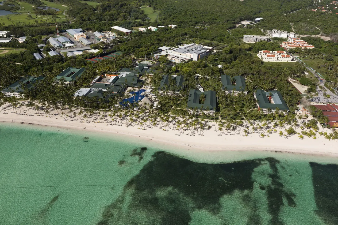 Overhead view of the beach, resort buildings, and shallow sea at Barceló Bávaro Beach.