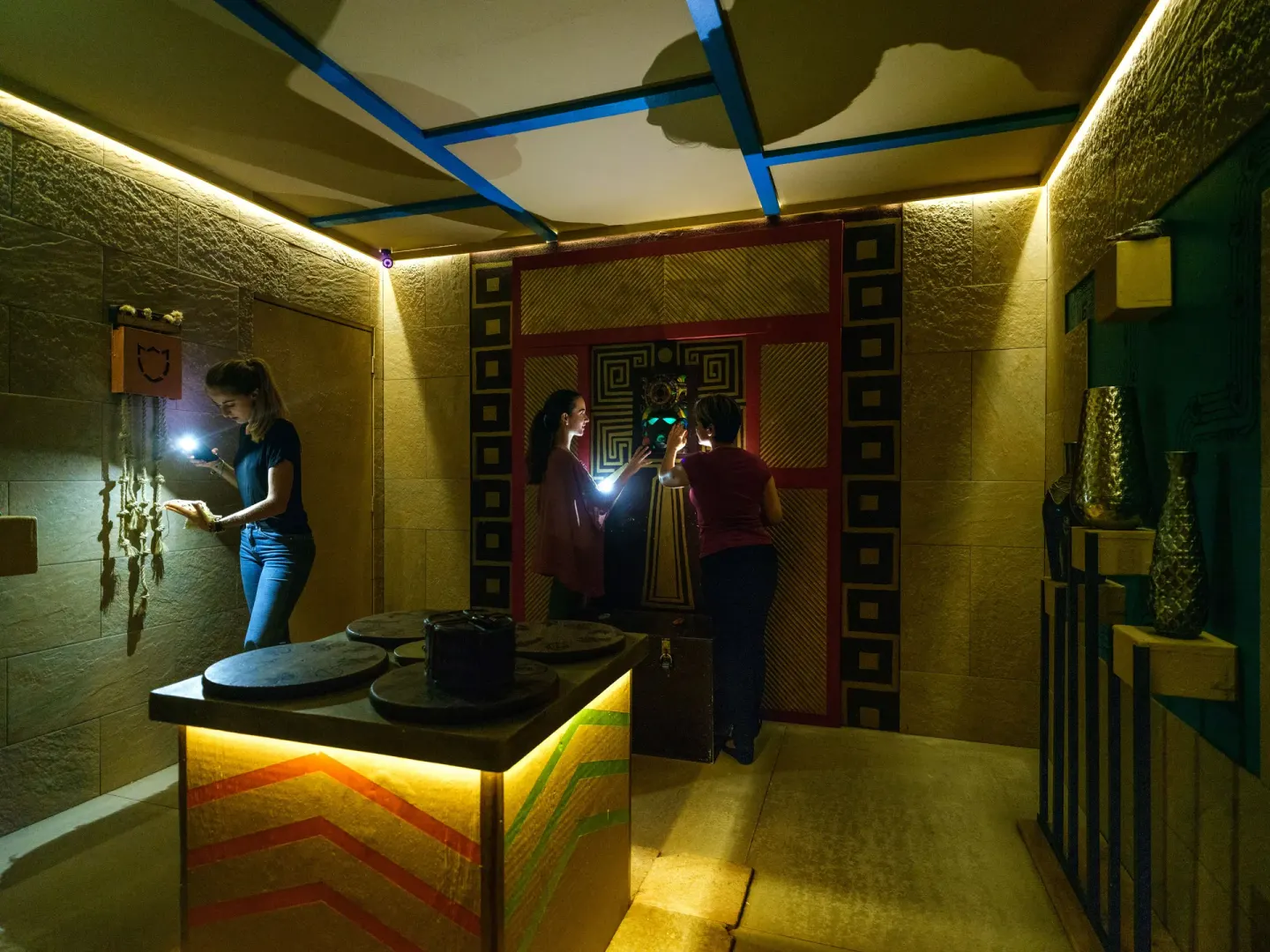 Guests use flashlights in a themed game room at Barceló Bávaro Beach.