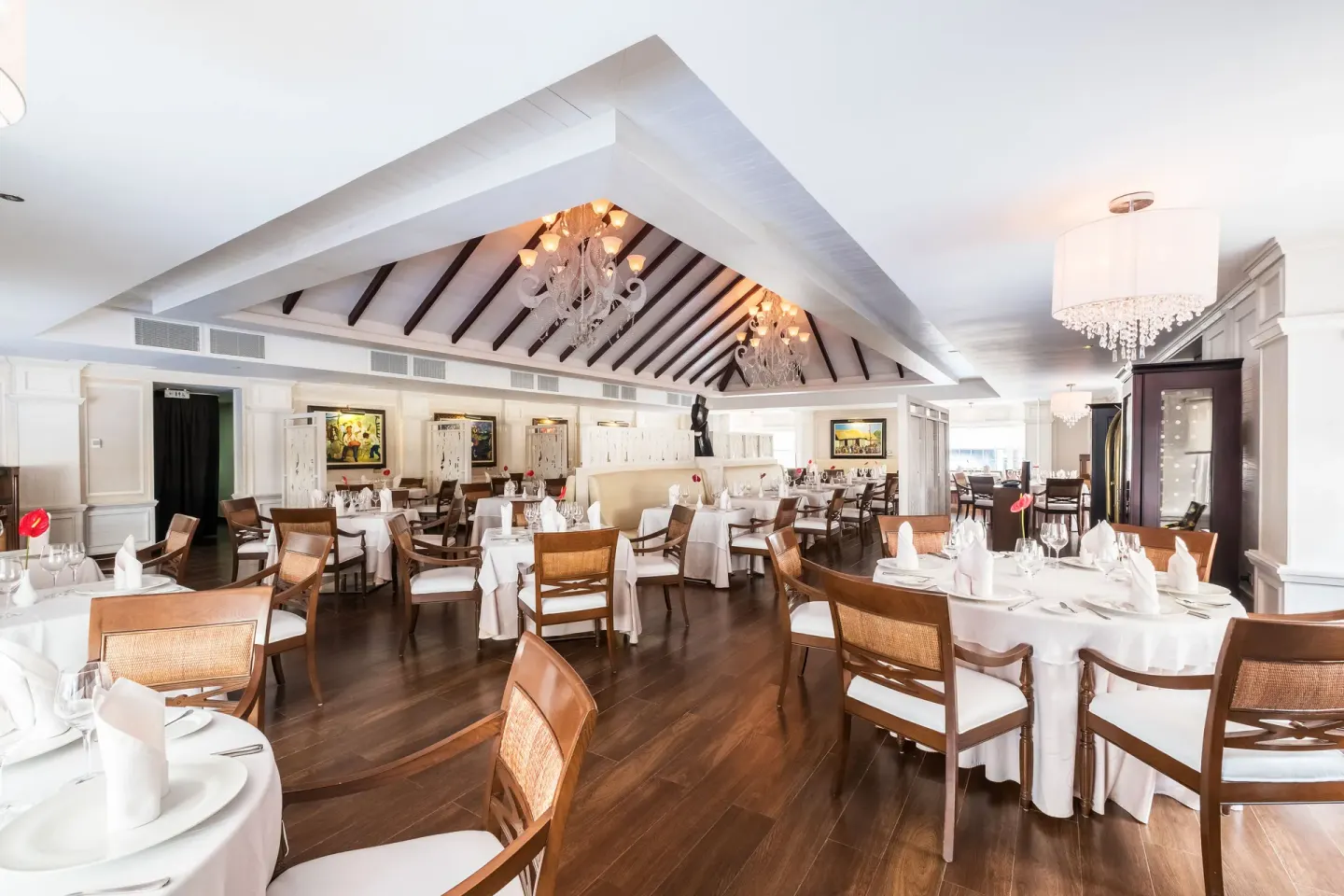 White-tablecloth dining room with chandeliers at Barceló Bávaro Beach.