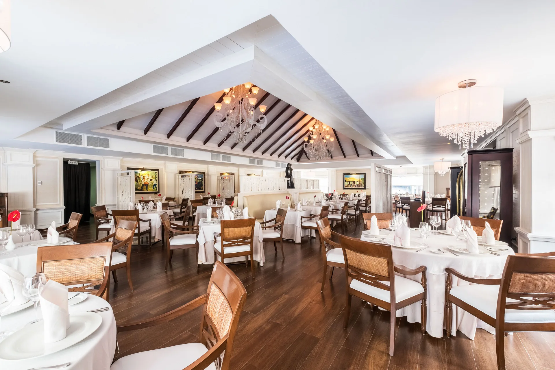 White-tablecloth dining room with chandeliers at Barceló Bávaro Beach.