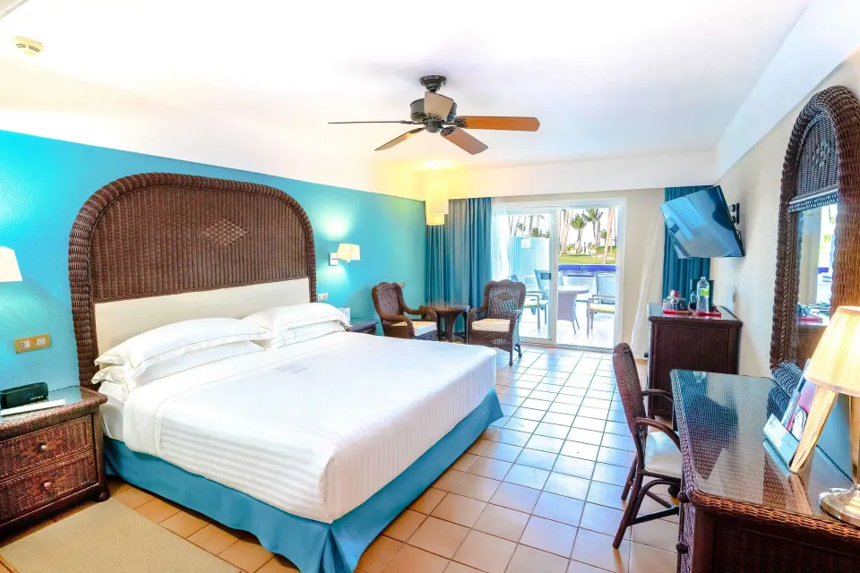 Superior Room Swim Up with king bed and patio view at Barceló Bávaro Beach.