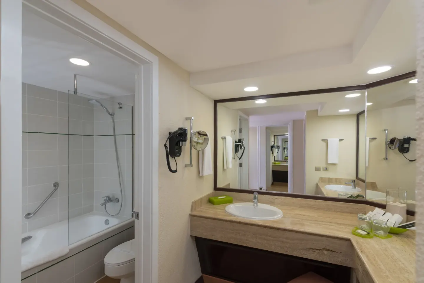 Superior Room bathroom vanity and tub shower at Barceló Bávaro Beach.