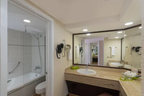 Superior Room bathroom vanity and tub shower at Barceló Bávaro Beach.