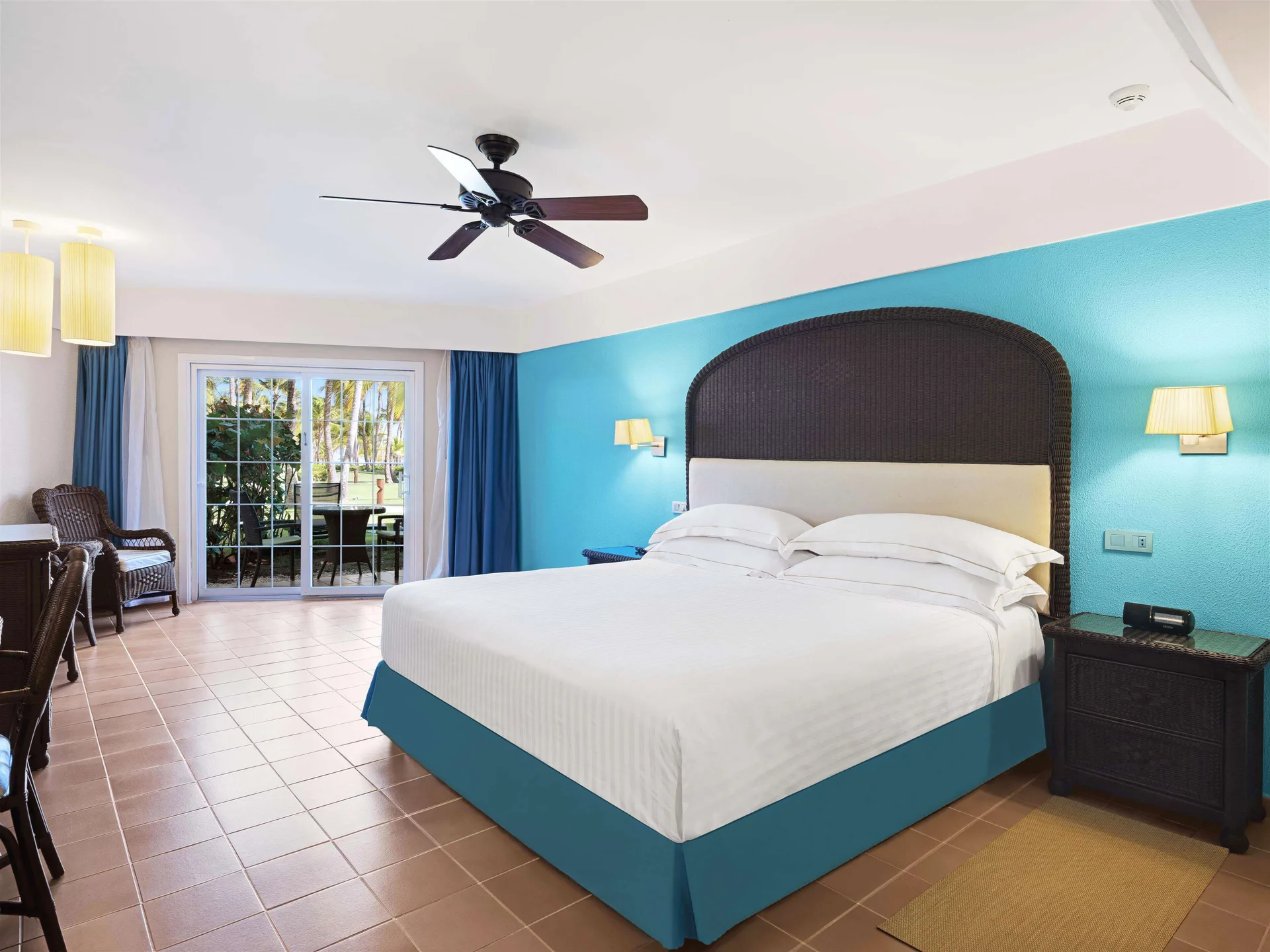 Superior Room king bed and patio doors at Barceló Bávaro Beach.
