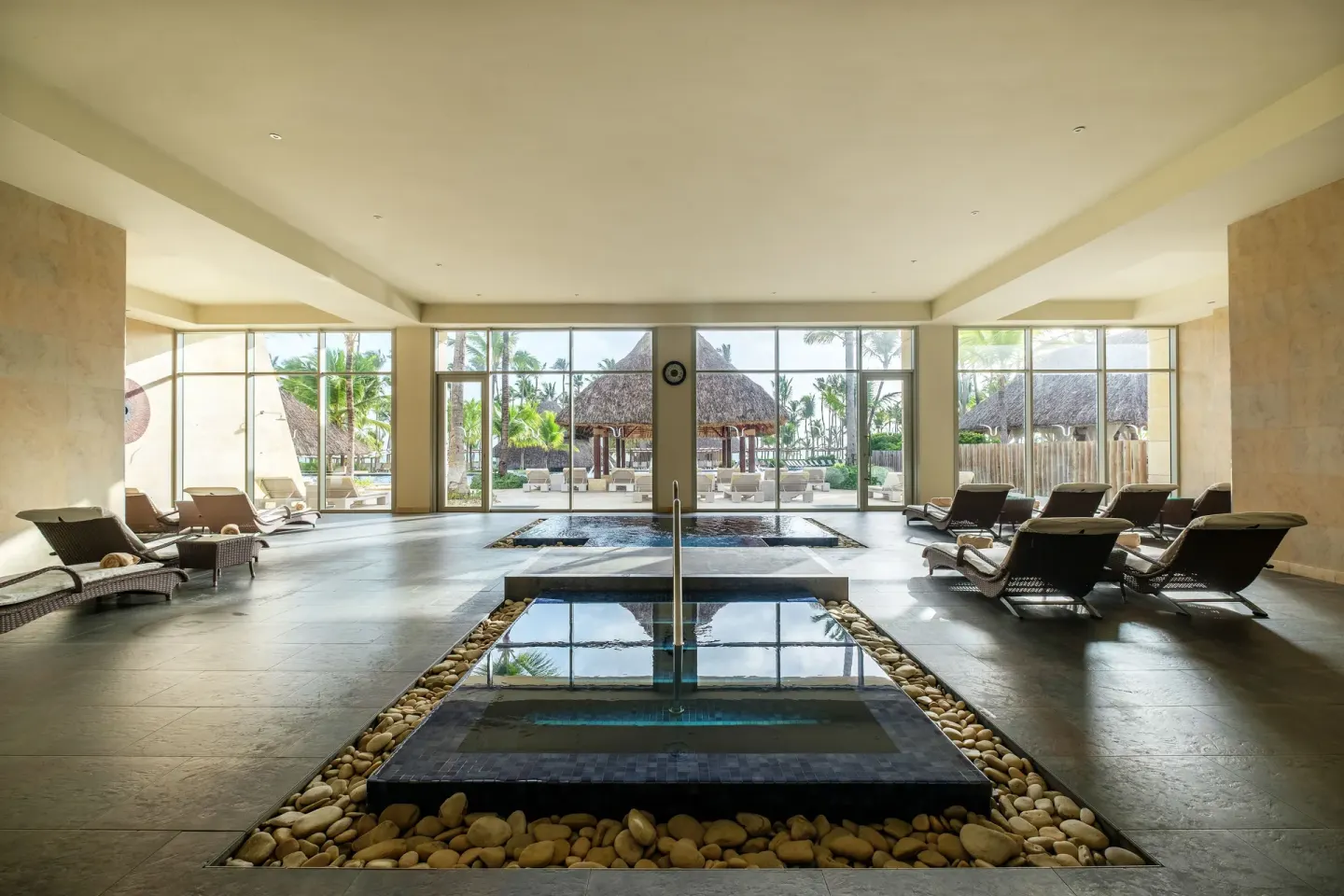 Indoor spa pools with loungers and garden views at Barceló Bávaro Palace.
