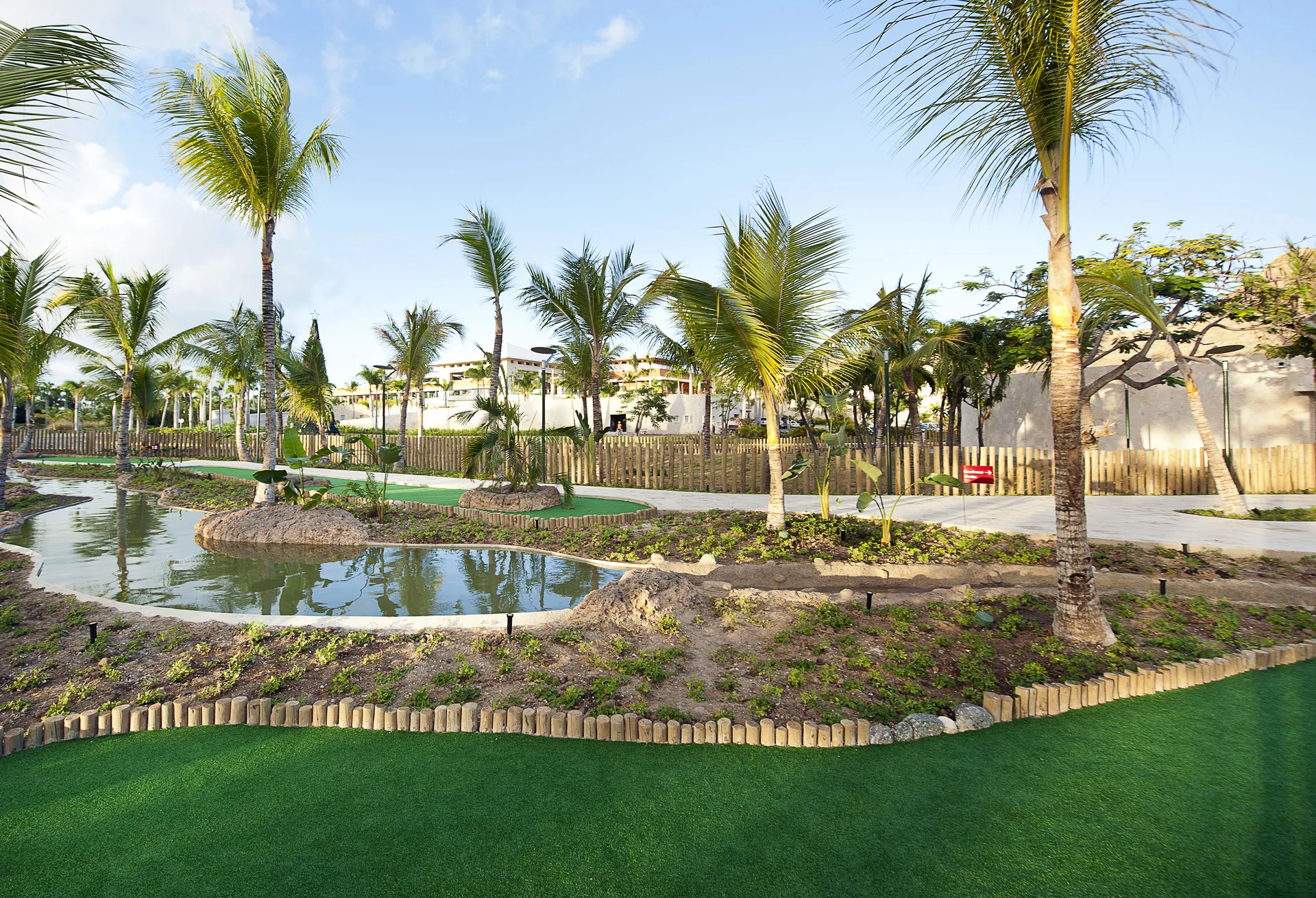 Landscaped mini golf course with palms and water features at Barceló Bávaro Palace.