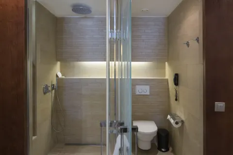 Family Duplex bathroom shower and toilet area with glass partition at Barceló Bávaro Palace.