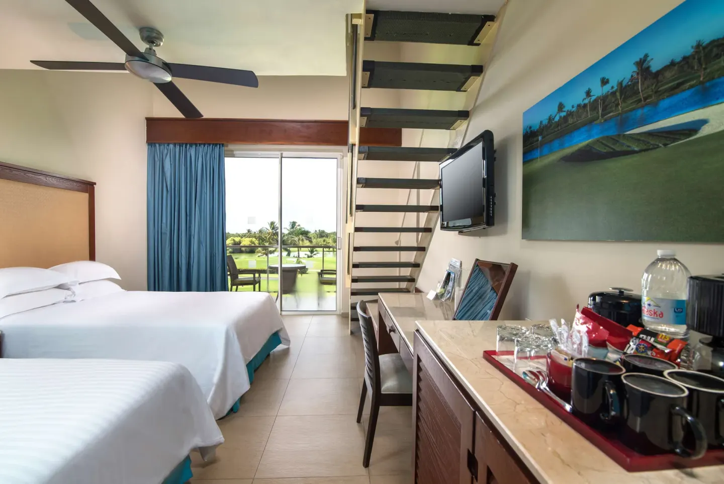 Family Duplex room with two beds, balcony, stairs and refreshment counter at Barceló Bávaro Palace.