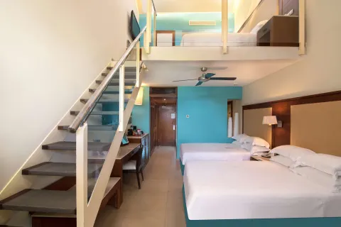 Family Duplex room with two beds, staircase and loft sleeping area at Barceló Bávaro Palace.