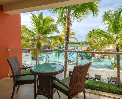 Family Room balcony with chairs overlooking the water play area at Barceló Bávaro Palace.