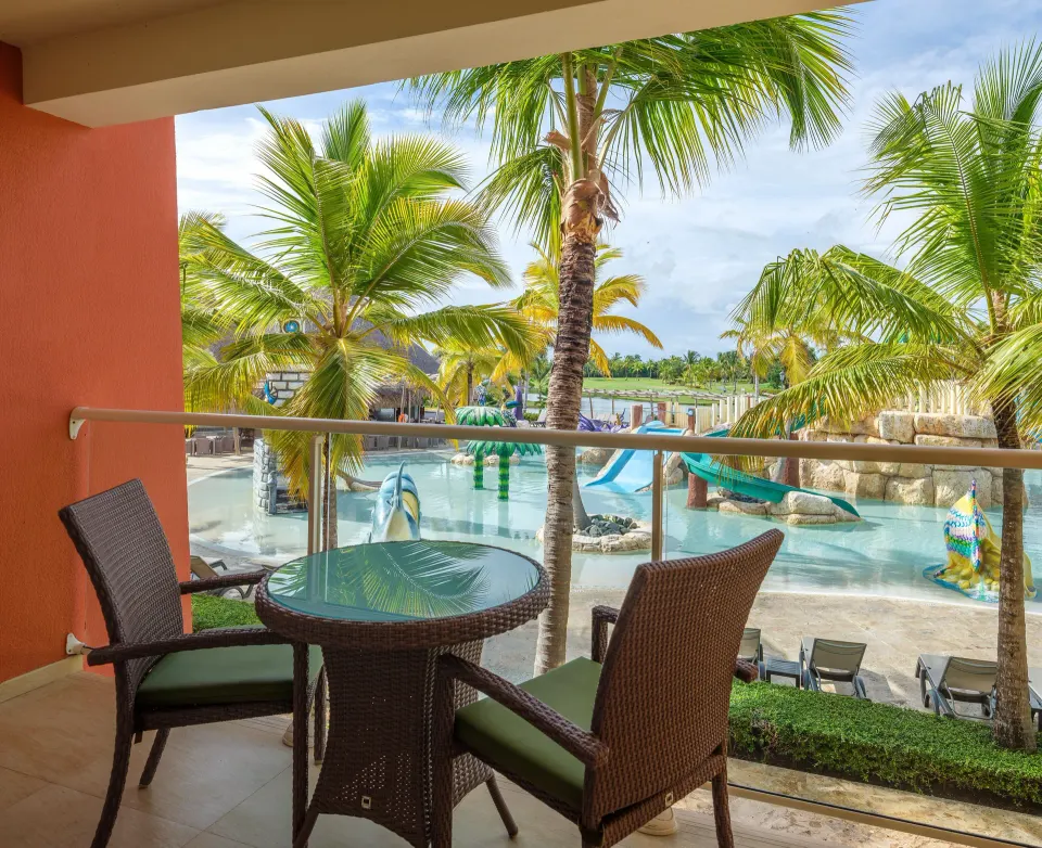Family Room balcony with chairs overlooking the water play area at Barceló Bávaro Palace.