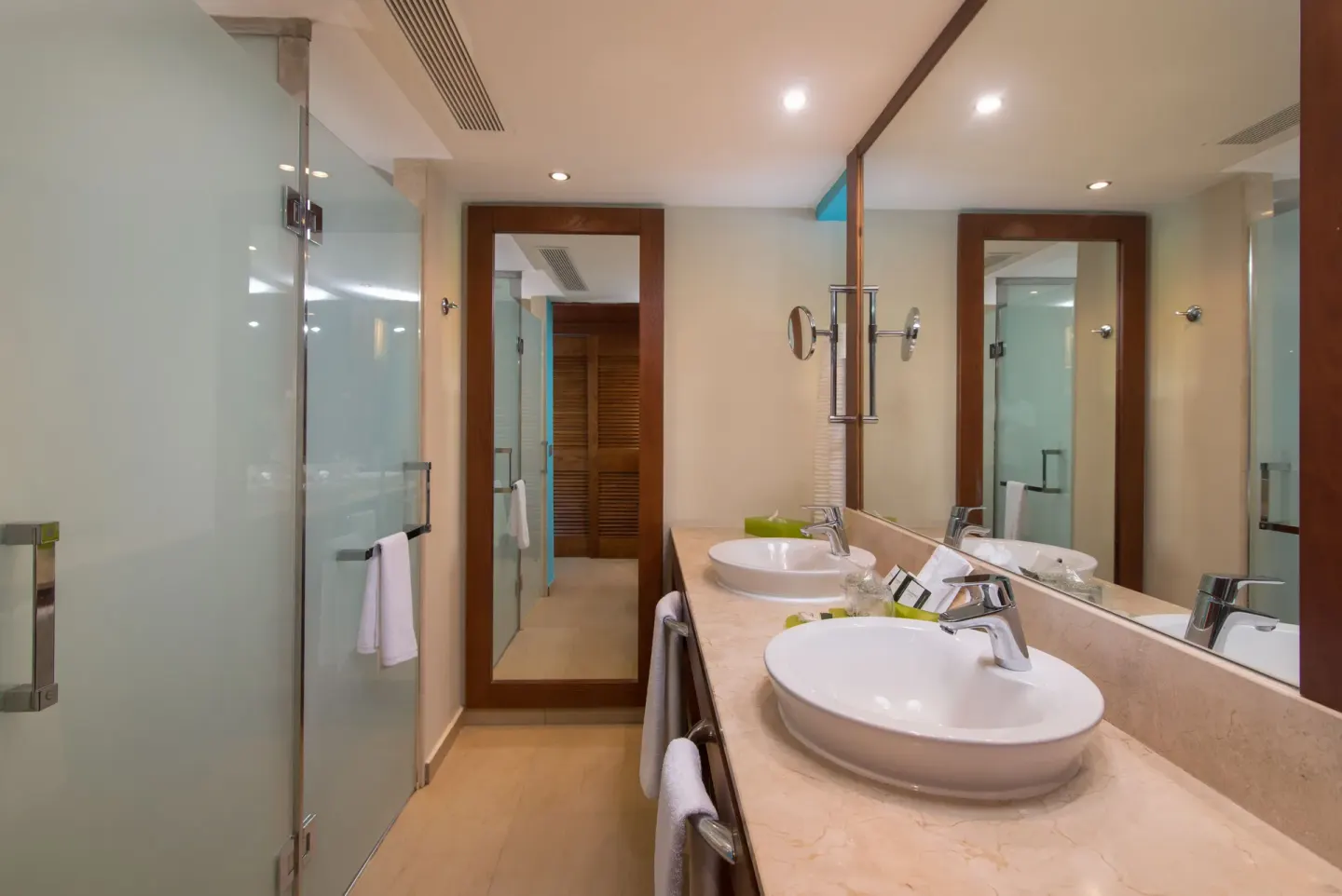 Family Room bathroom with double sinks and glass shower at Barceló Bávaro Palace.