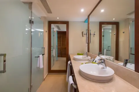 Family Room bathroom with double sinks and glass shower at Barceló Bávaro Palace.