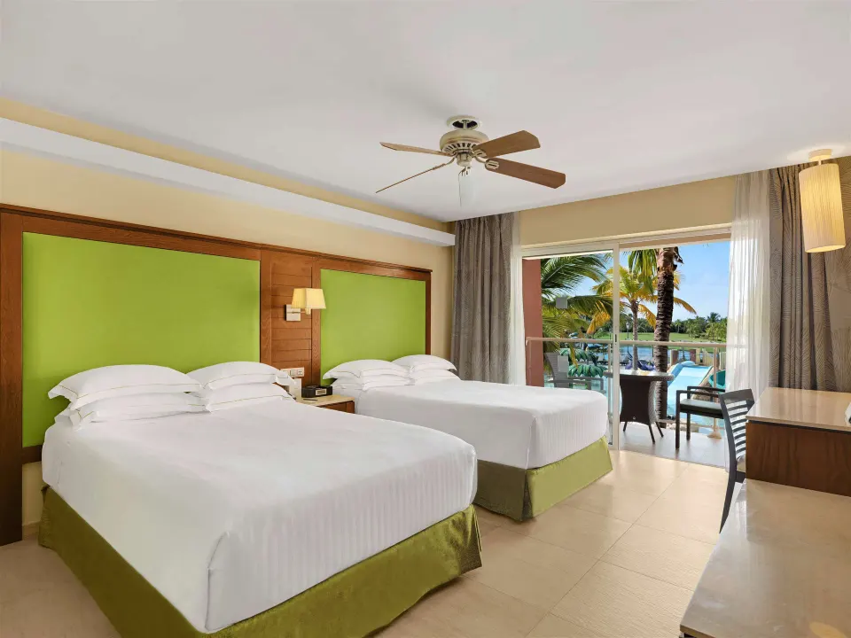 Family Room with two beds and balcony view at Barceló Bávaro Palace.