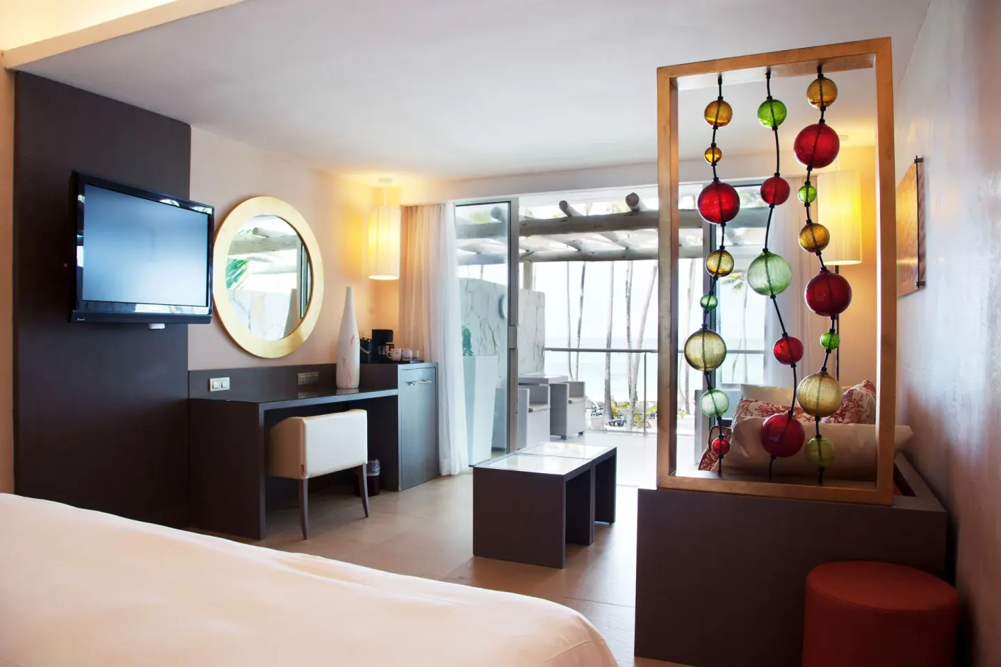 Junior Suite Sea View with bed, lounge, desk, and balcony at Barceló Bávaro Palace.