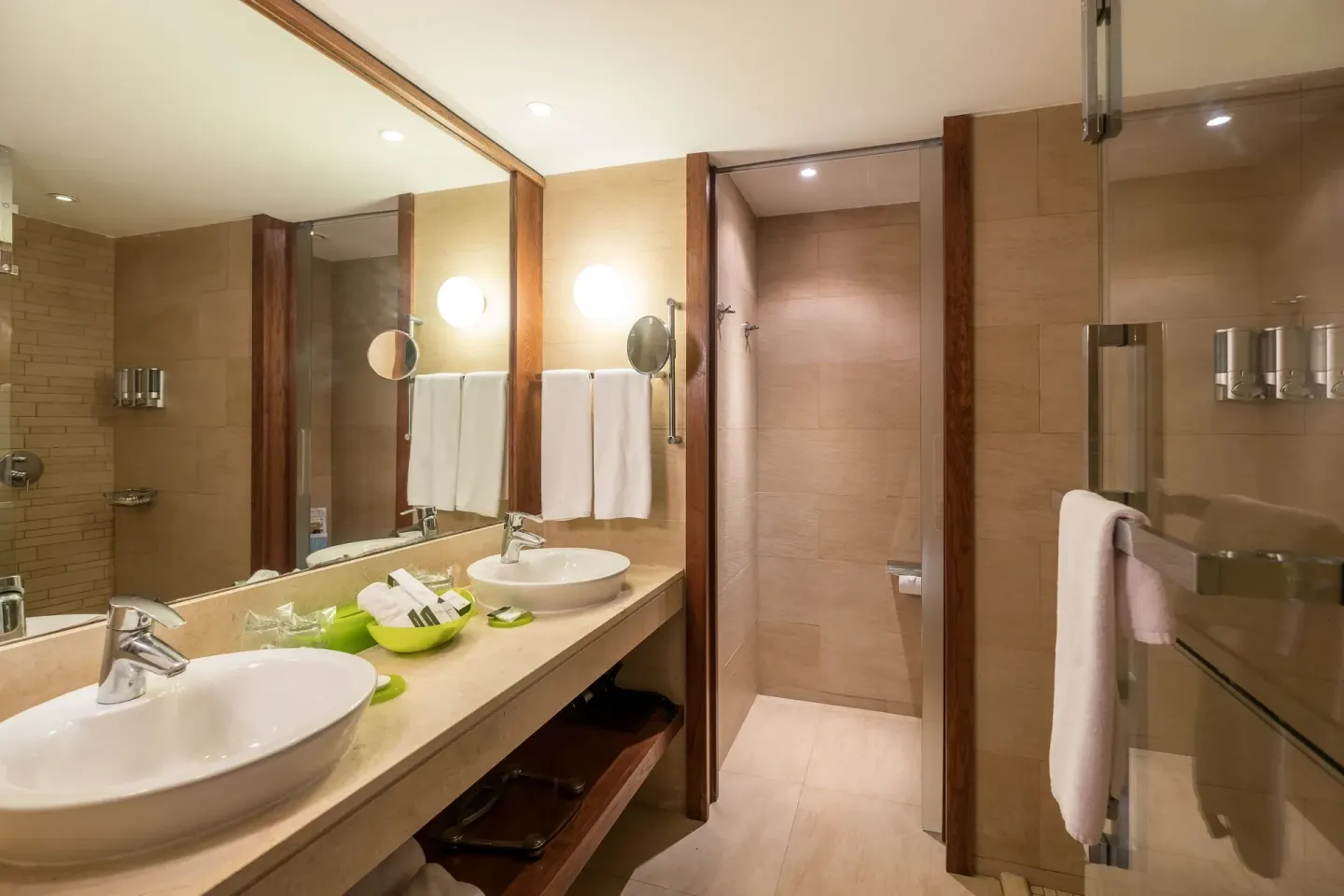 Suite bathroom with double sinks and glass shower at Barceló Bávaro Palace.
