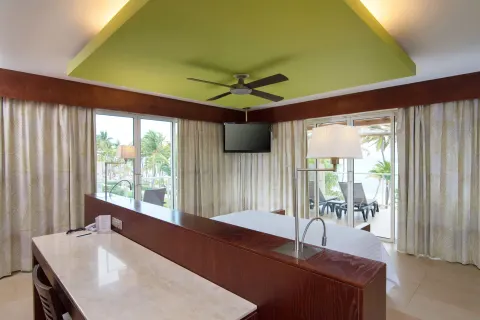 Panoramic sea view suite with king bed and desk at Barceló Bávaro Palace.