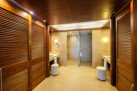 Sea View Suite bathroom at Barceló Bávaro Palace with wood closets, twin vanities, and glass shower.