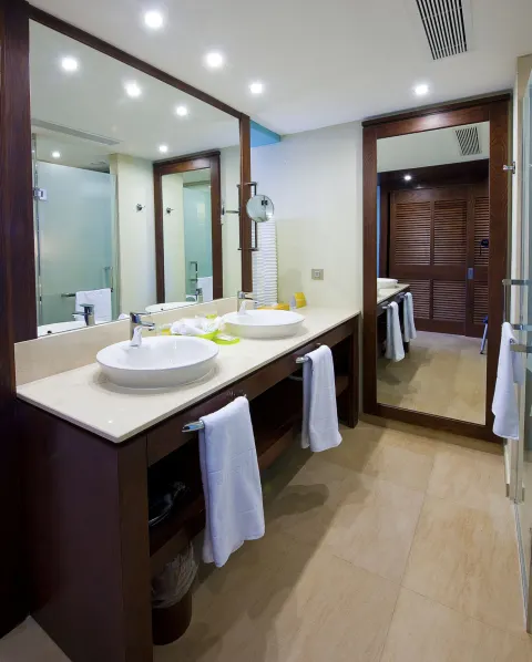 Superior Room bathroom with double sinks and large mirrors at Barceló Bávaro Palace.