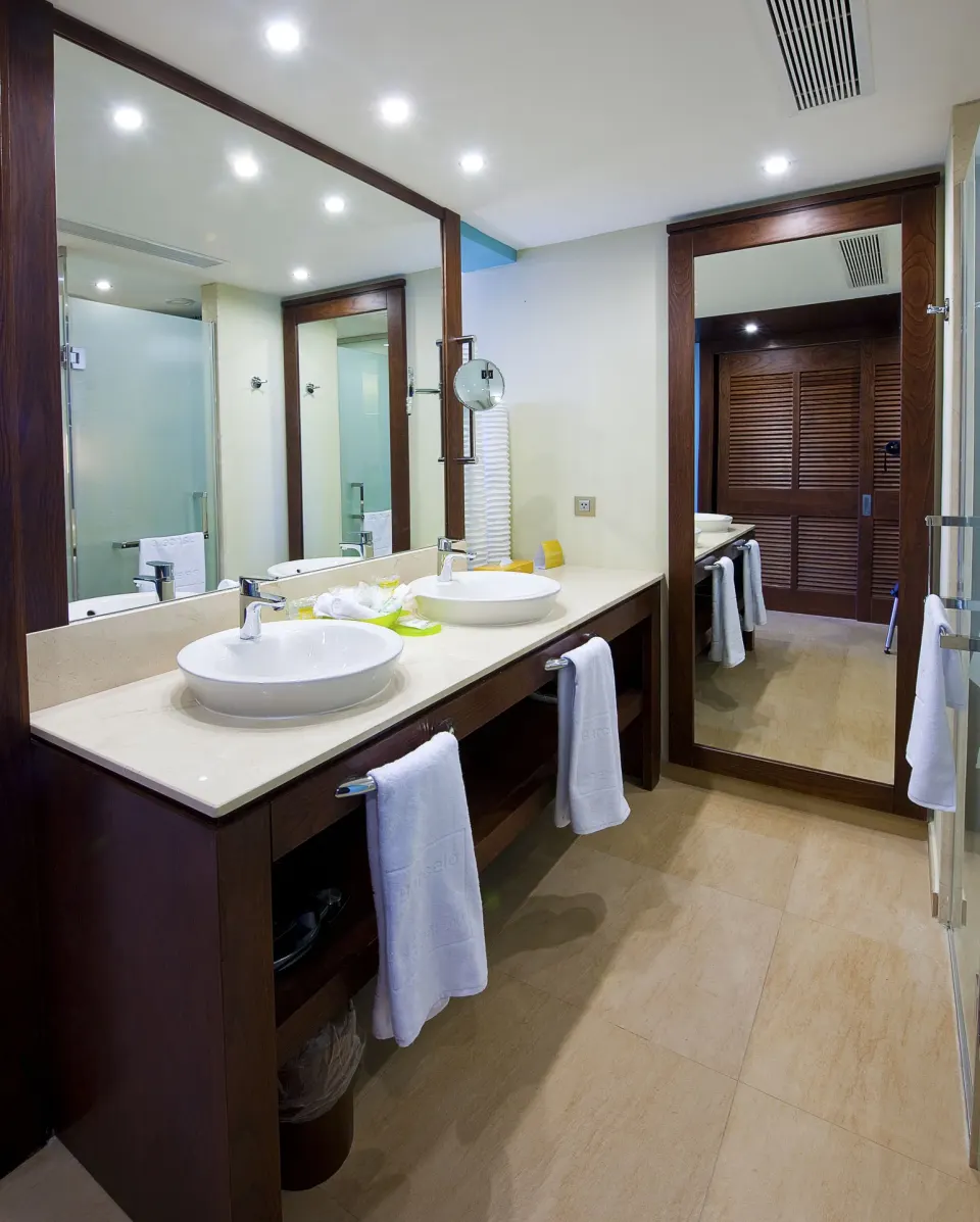 Superior Room bathroom with double sinks and large mirrors at Barceló Bávaro Palace.