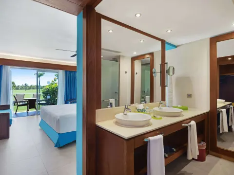 Superior Room vanity beside the bed and terrace doors at Barceló Bávaro Palace.