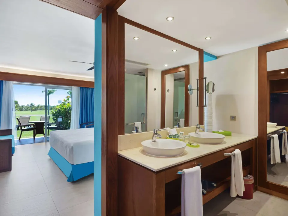 Superior Room vanity beside the bed and terrace doors at Barceló Bávaro Palace.