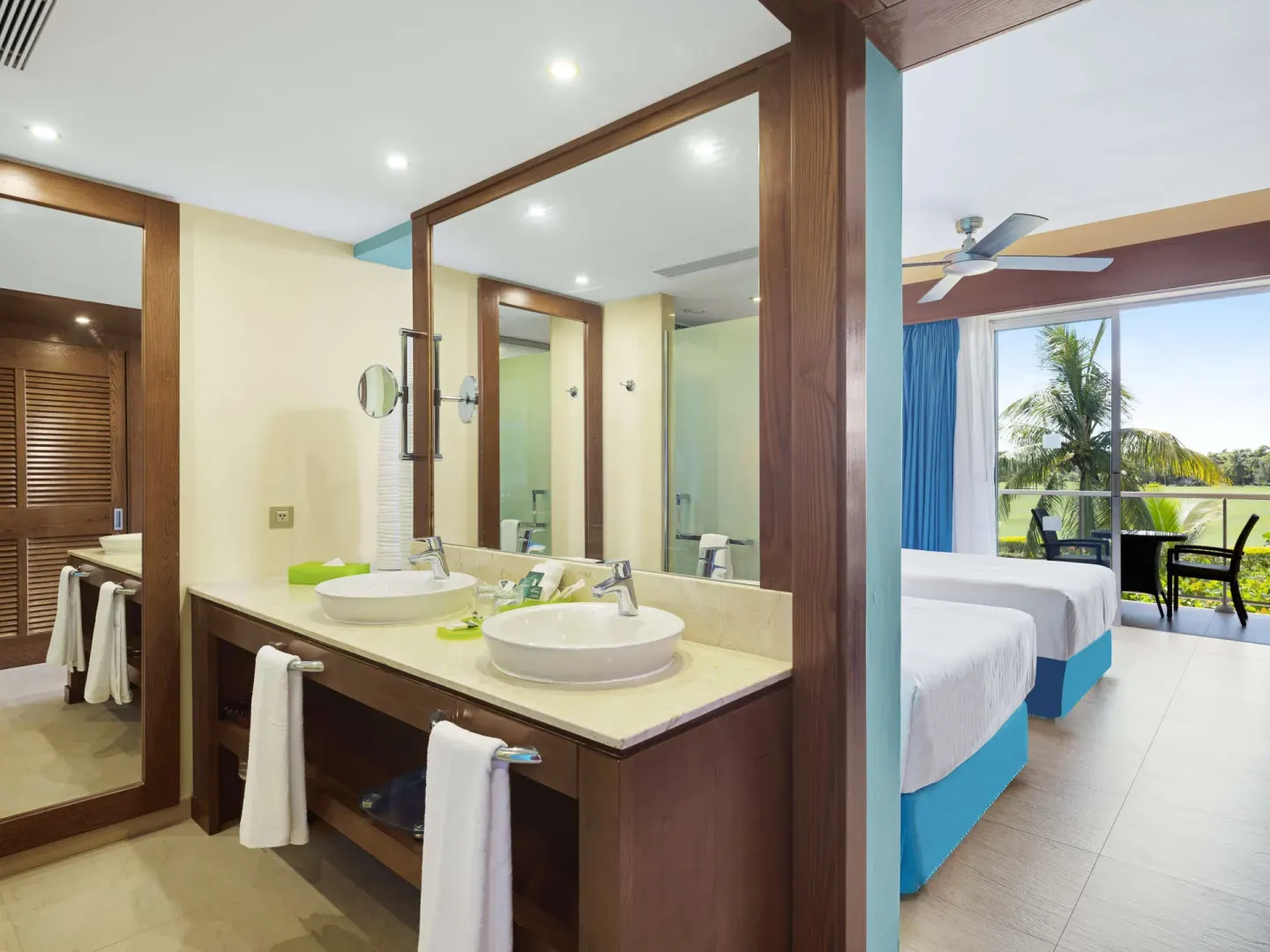 Superior Room bathroom and two beds with balcony at Barceló Bávaro Palace.