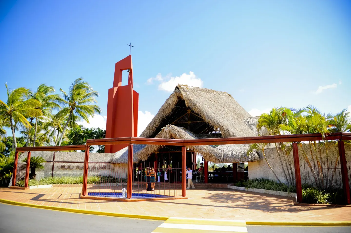 A thatched resort chapel with a red bell tower at Barceló Bávaro Palace.