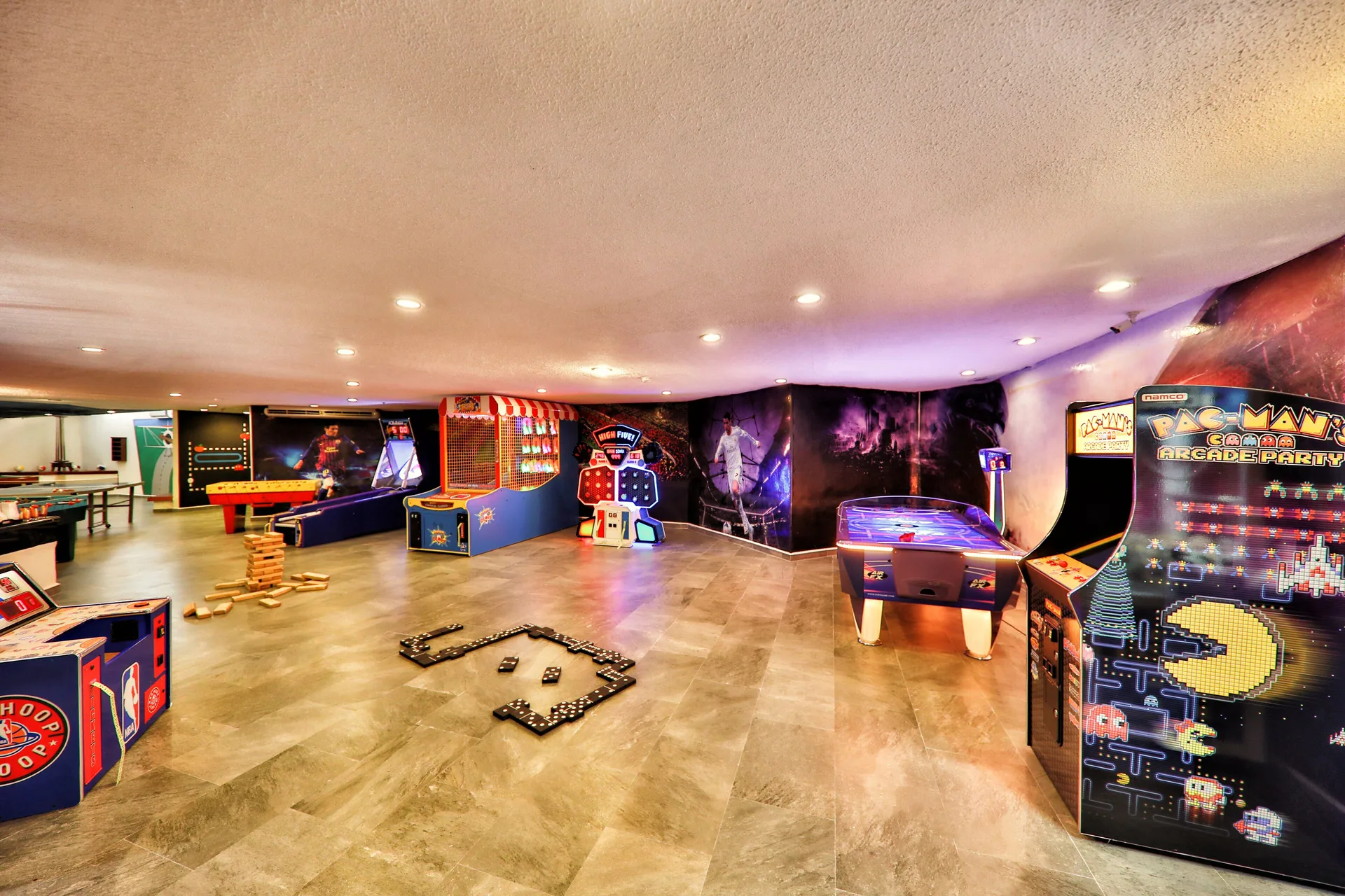 Arcade room with video games, air hockey, and game tables at Barceló Huatulco.