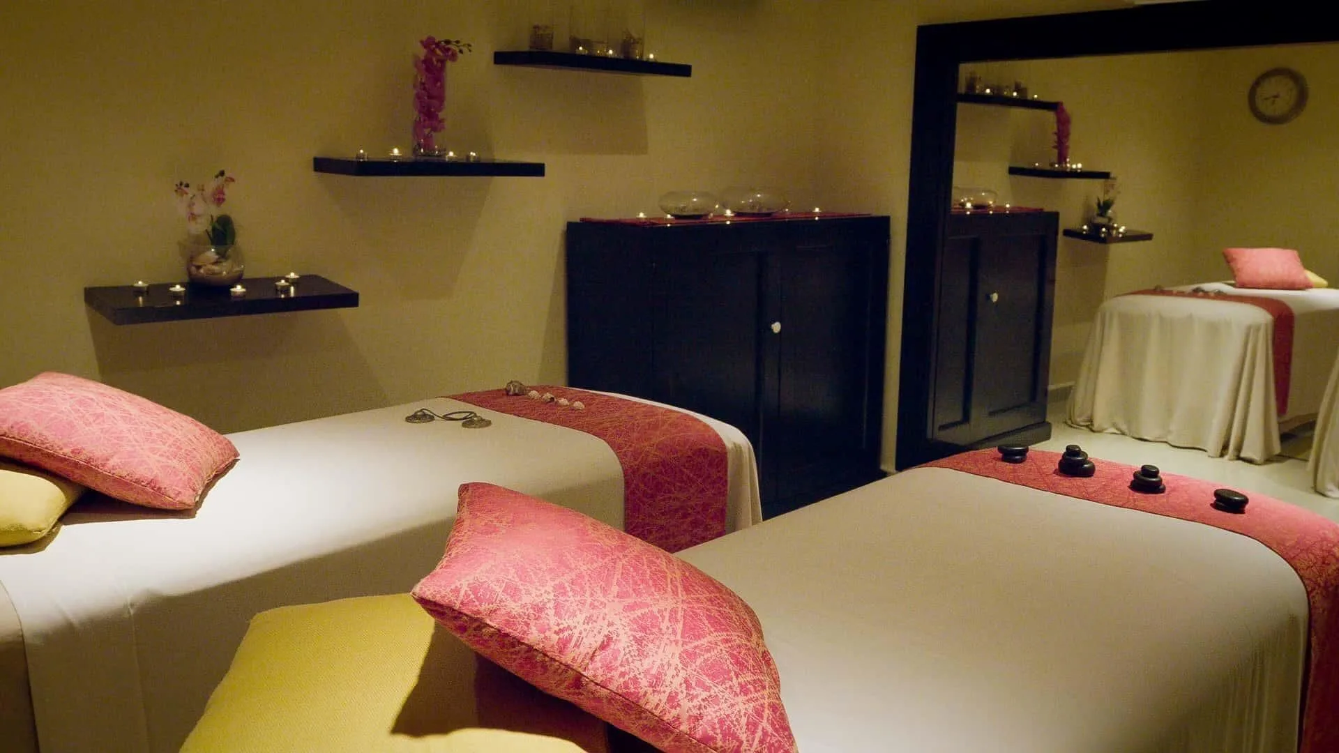 Candlelit spa treatment room with massage beds at Barceló Huatulco.