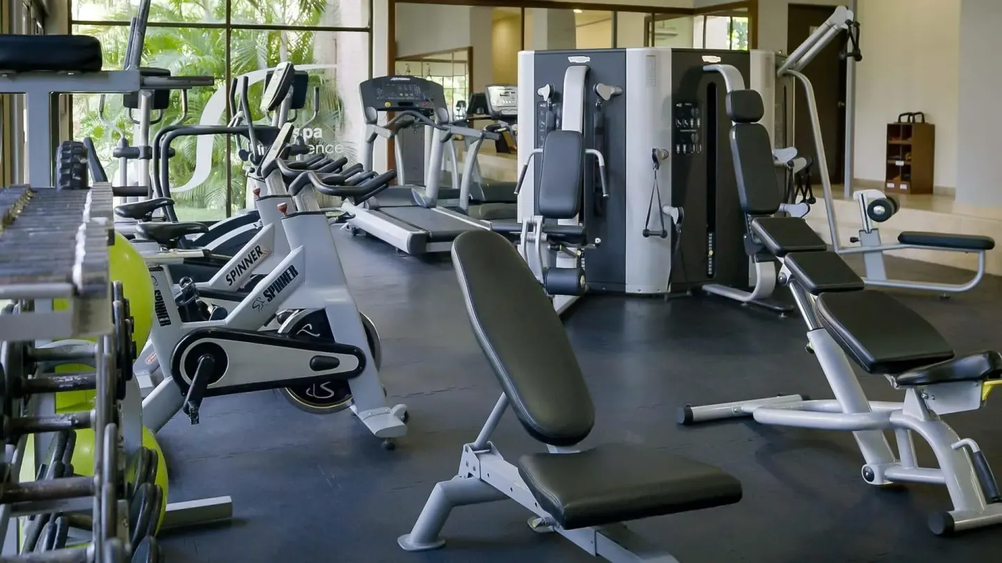 Fitness center with bikes, benches, treadmills, and weight machines at Barceló Huatulco.