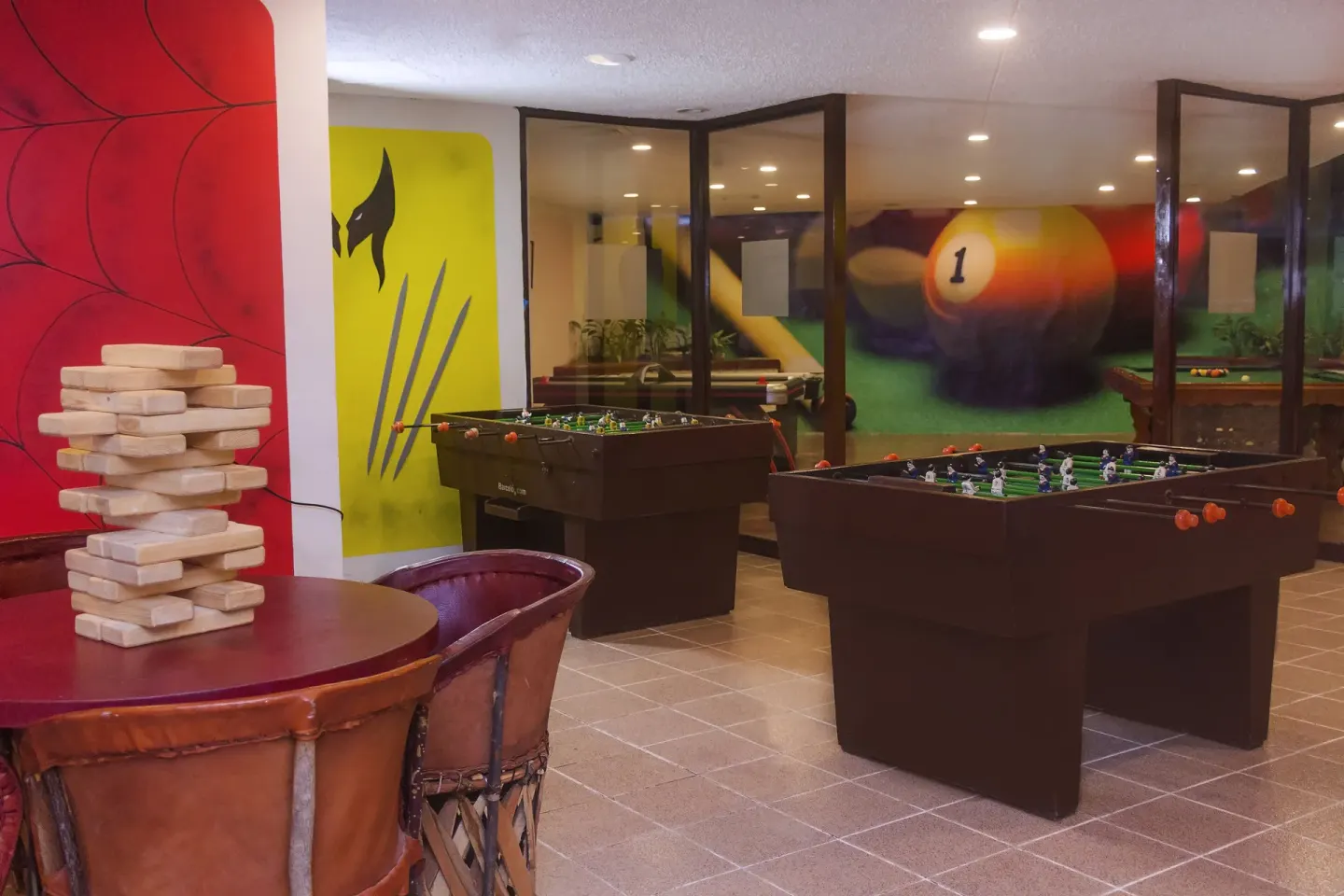 Game room with foosball tables and a block-stacking game at Barceló Huatulco.