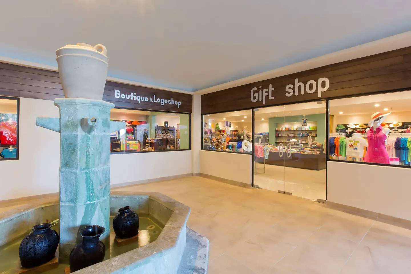 Gift shop storefronts and a fountain inside Barceló Huatulco.
