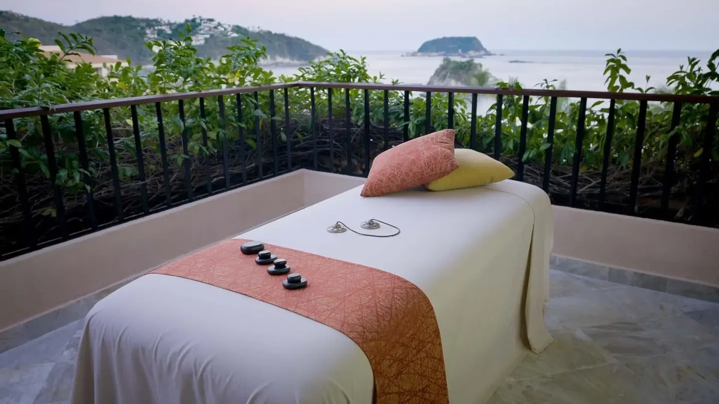 Outdoor massage bed on a terrace overlooking the coast at Barceló Huatulco.