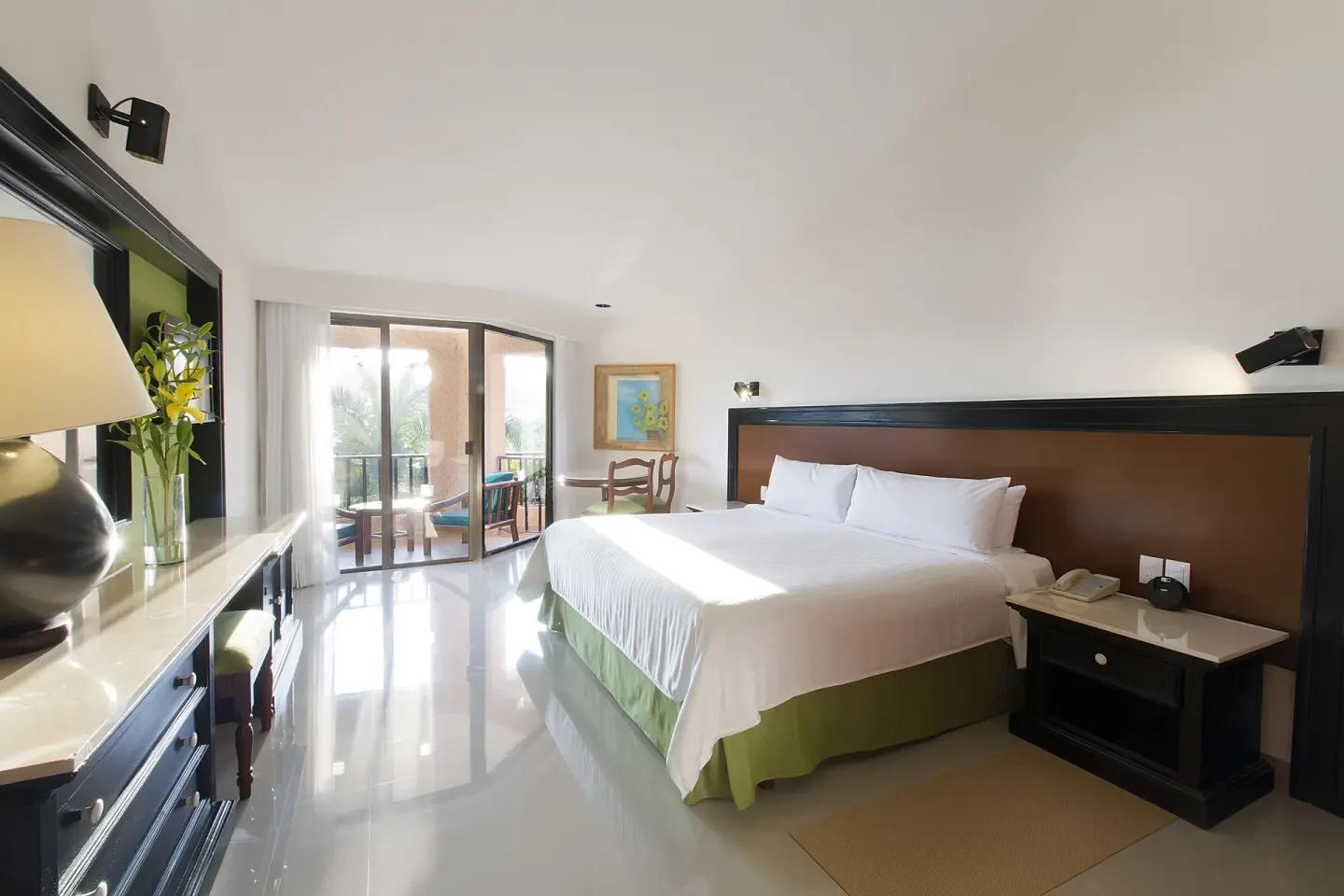 Deluxe Garden View room with a king bed and balcony seating at Barceló Huatulco.